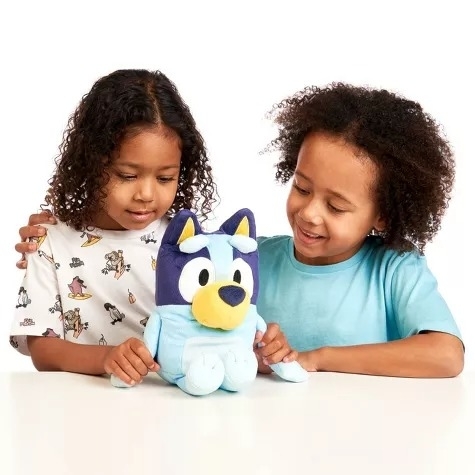 Two kids play with Bluey