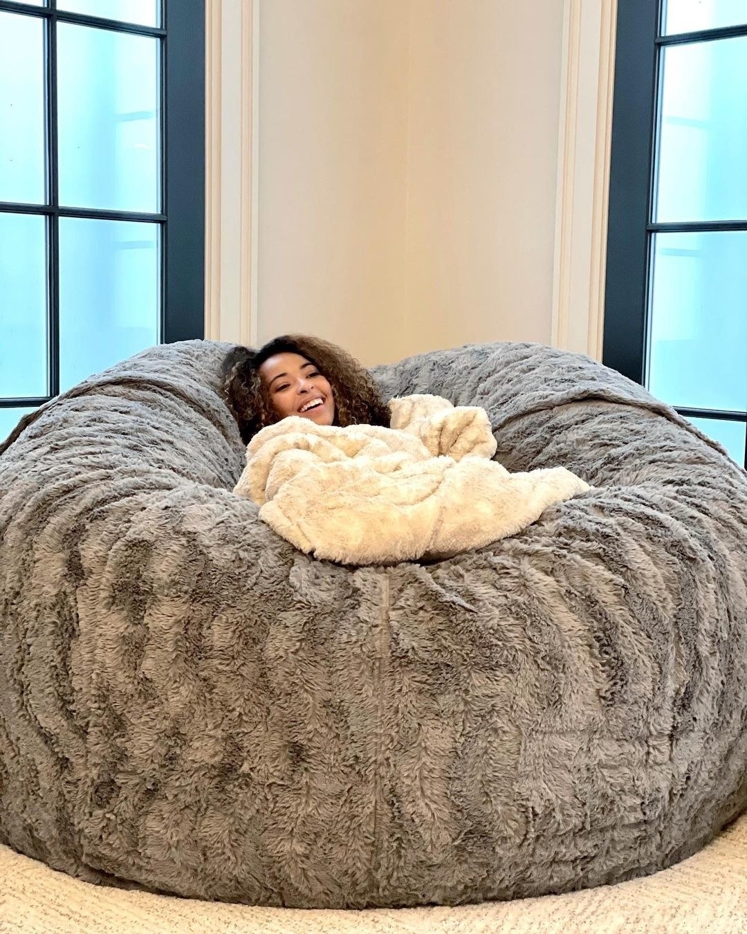 a model comfortably sitting in the middle of the lovesac