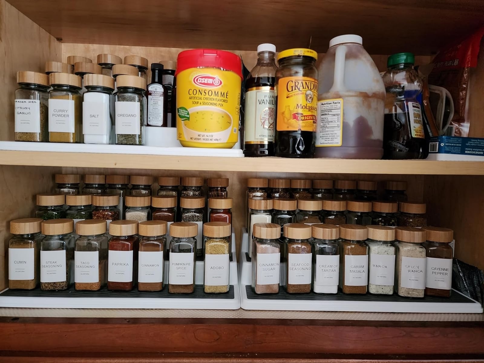 a reviewer&#x27;s pantry with multiple shelf organizers organizing spice jars