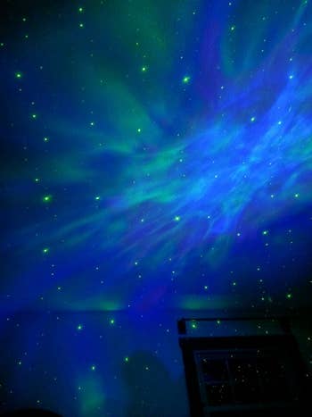 A blue/green nebula projected on a ceiling