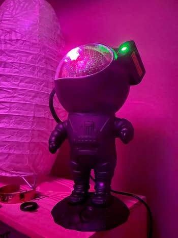 The astronaut figure with the projector in its helmet visor