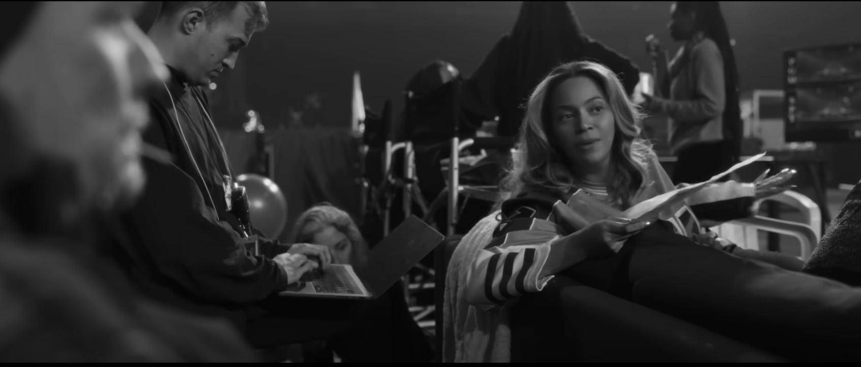 Beyoncé sitting and talking with others