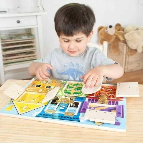 A toddler plays with a busy board