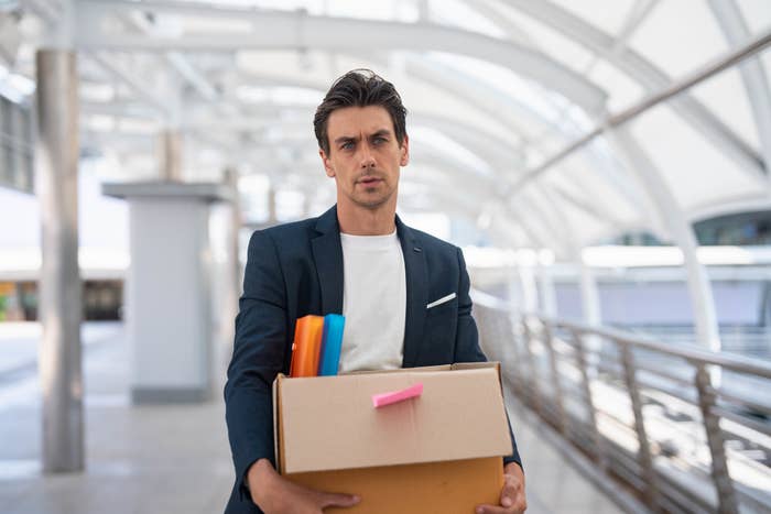 A man holding a box of office supplies
