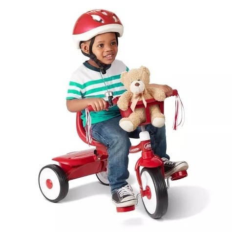 A toddler rides a tricycle