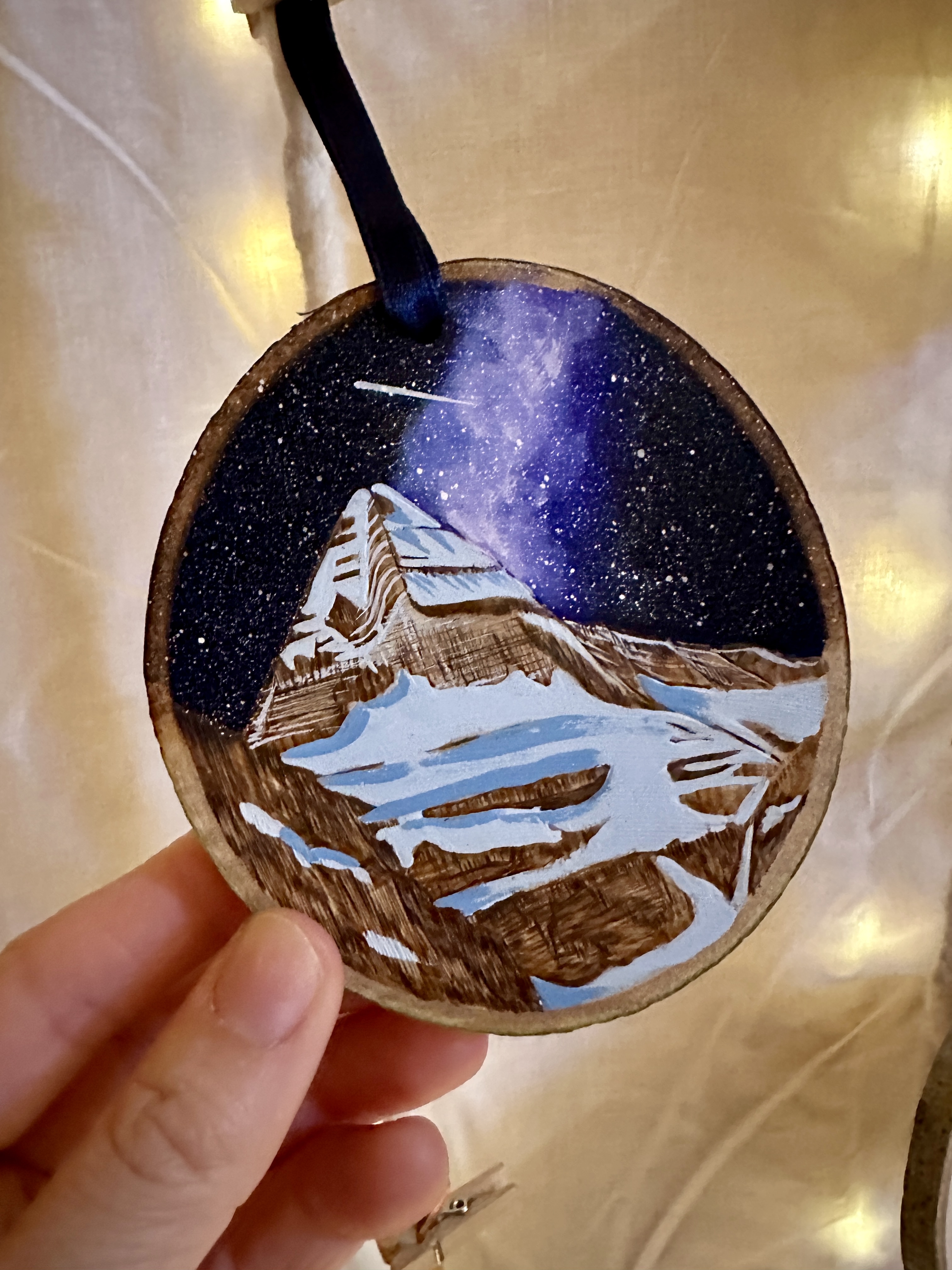 An ornament with a snow capped mountain on it.