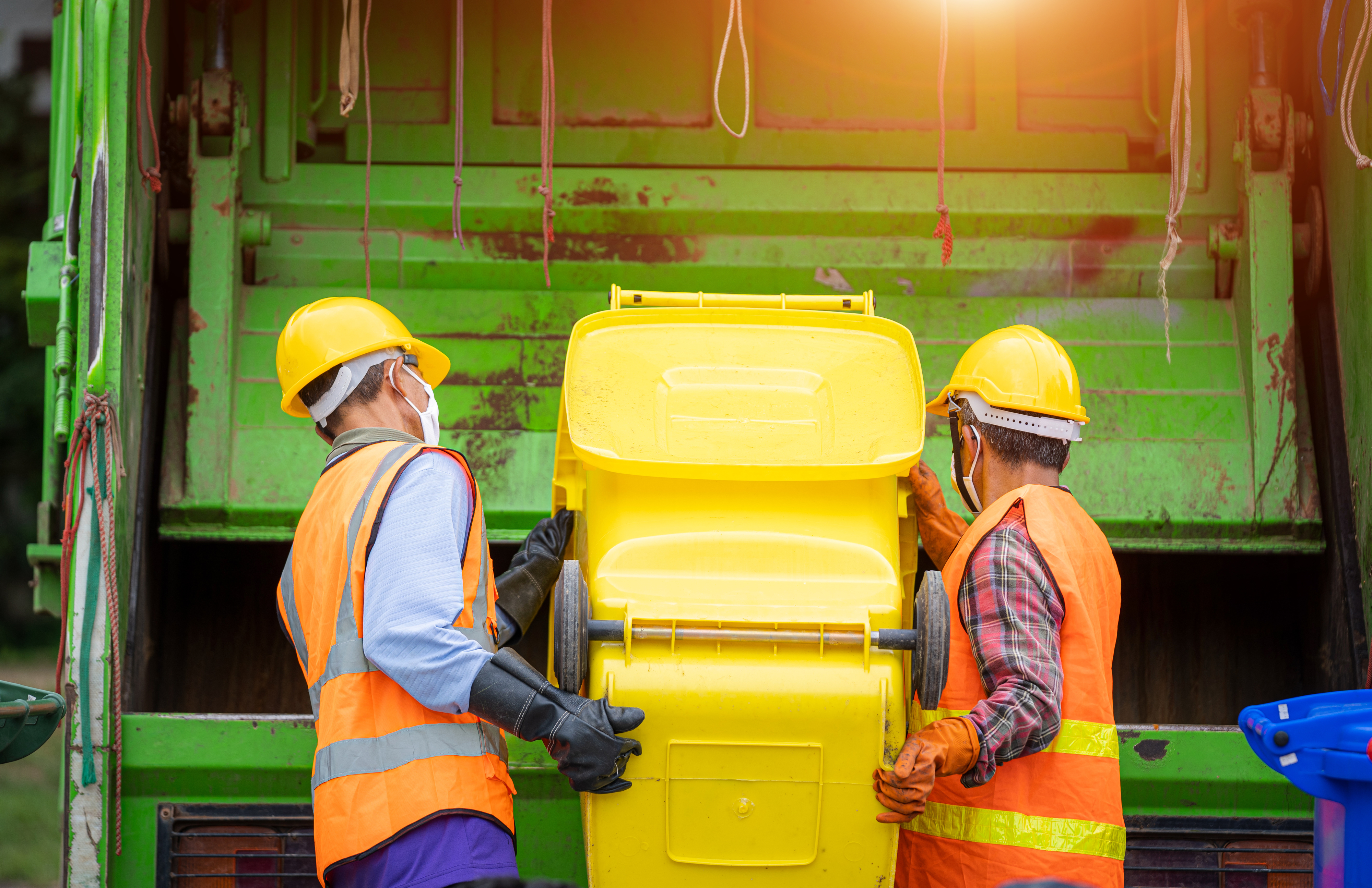 Men loading garbage into a truck