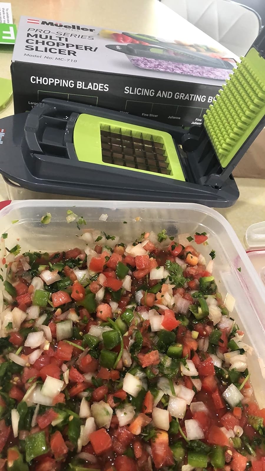 A reviewer&#x27;s chopper next to a container filled with chopped veggies