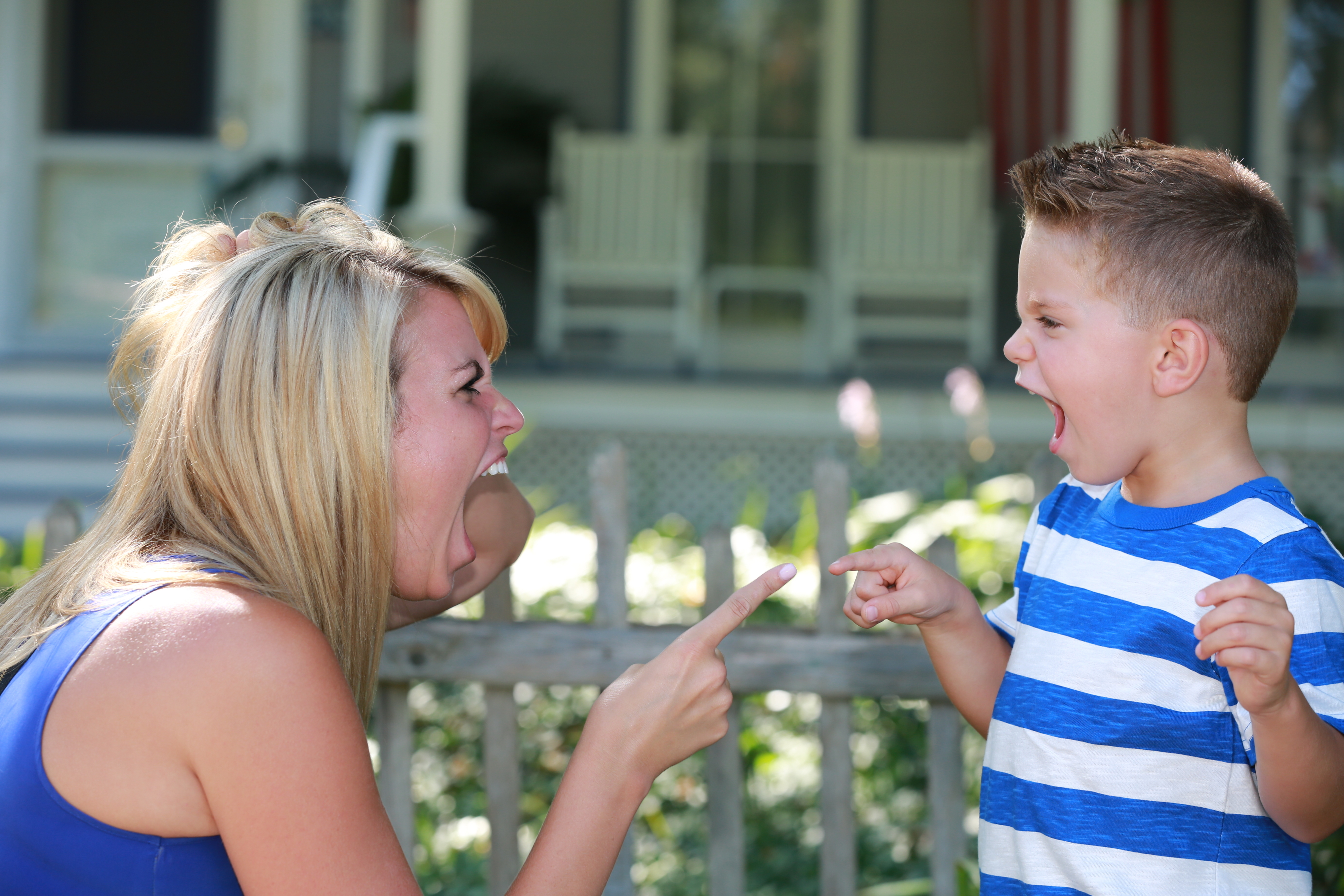 A mother and son yelling and pointing at each other