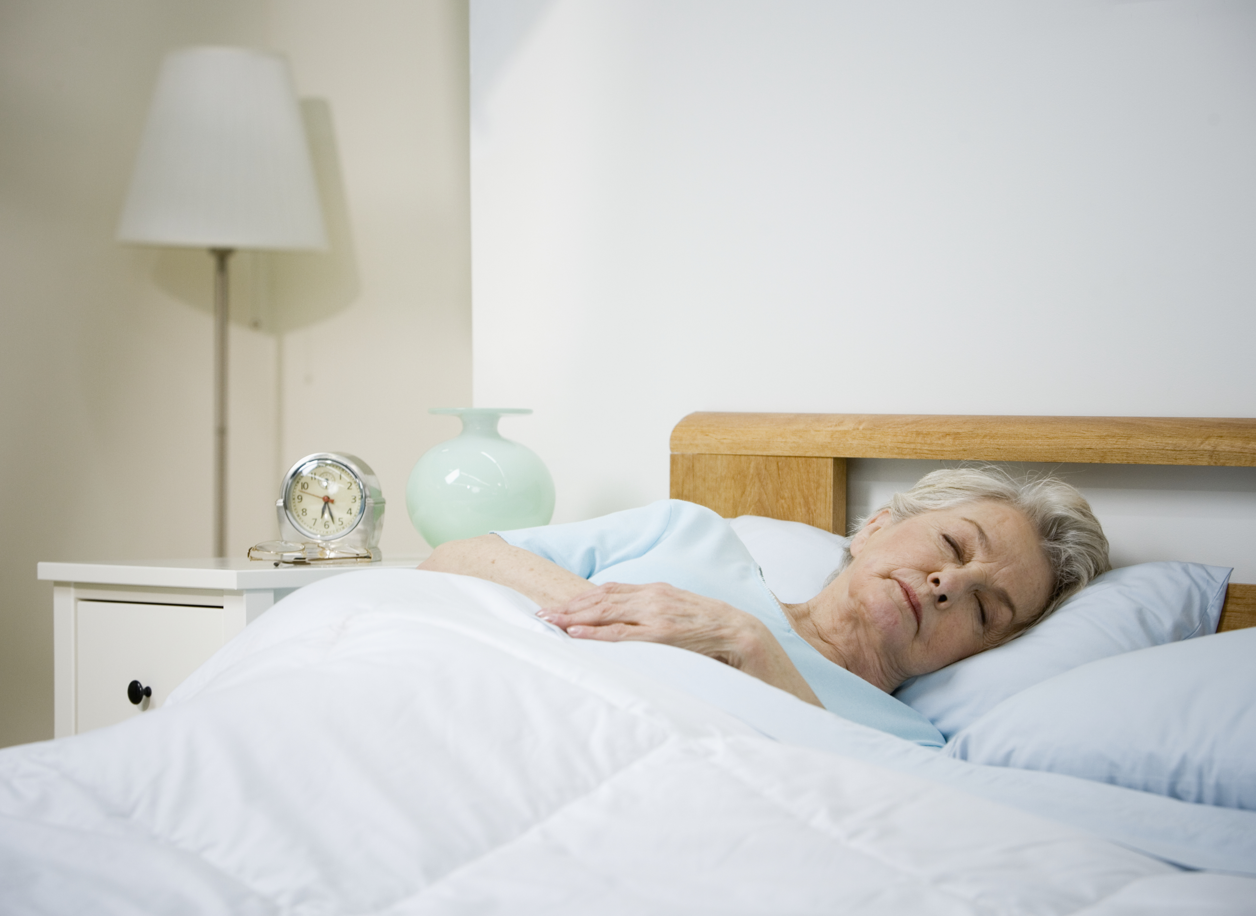 An older woman asleep in bed