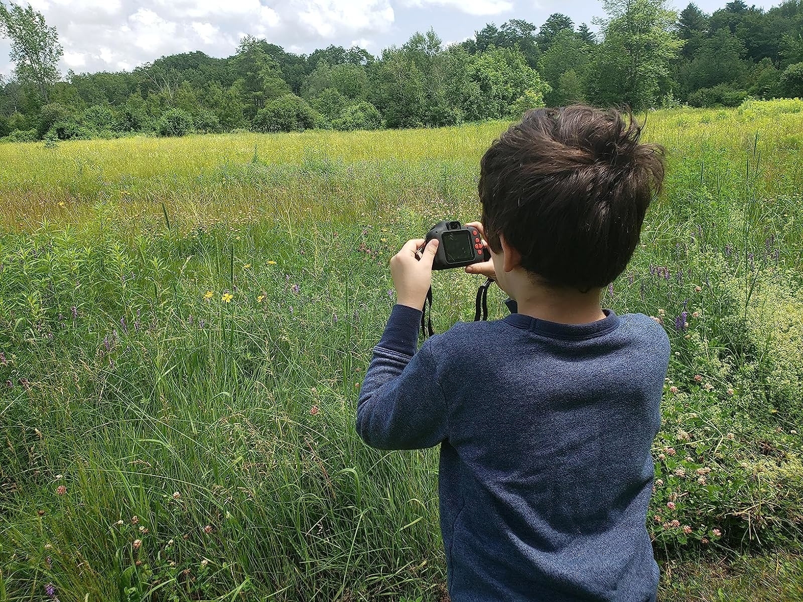 reviewer&#x27;s child with camera taking a picture