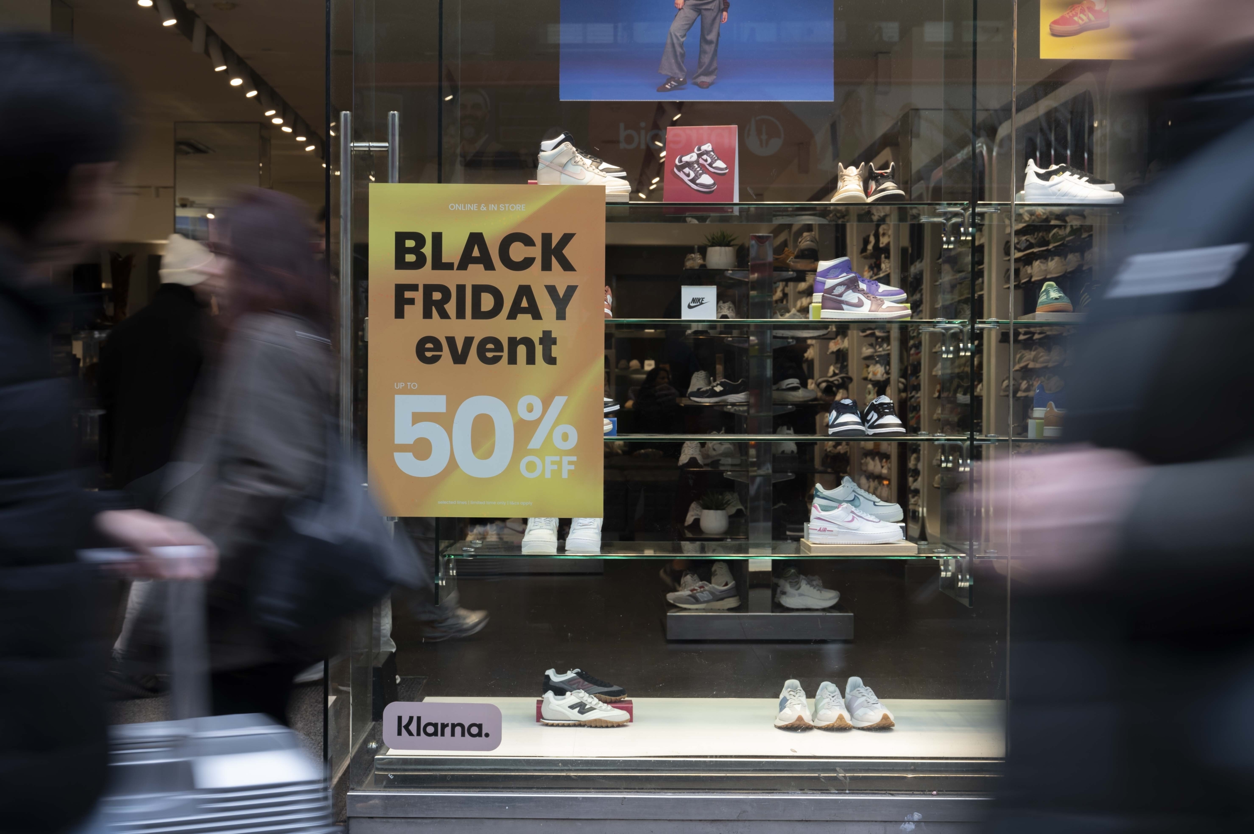 store window sign advertising black friday event 50% off