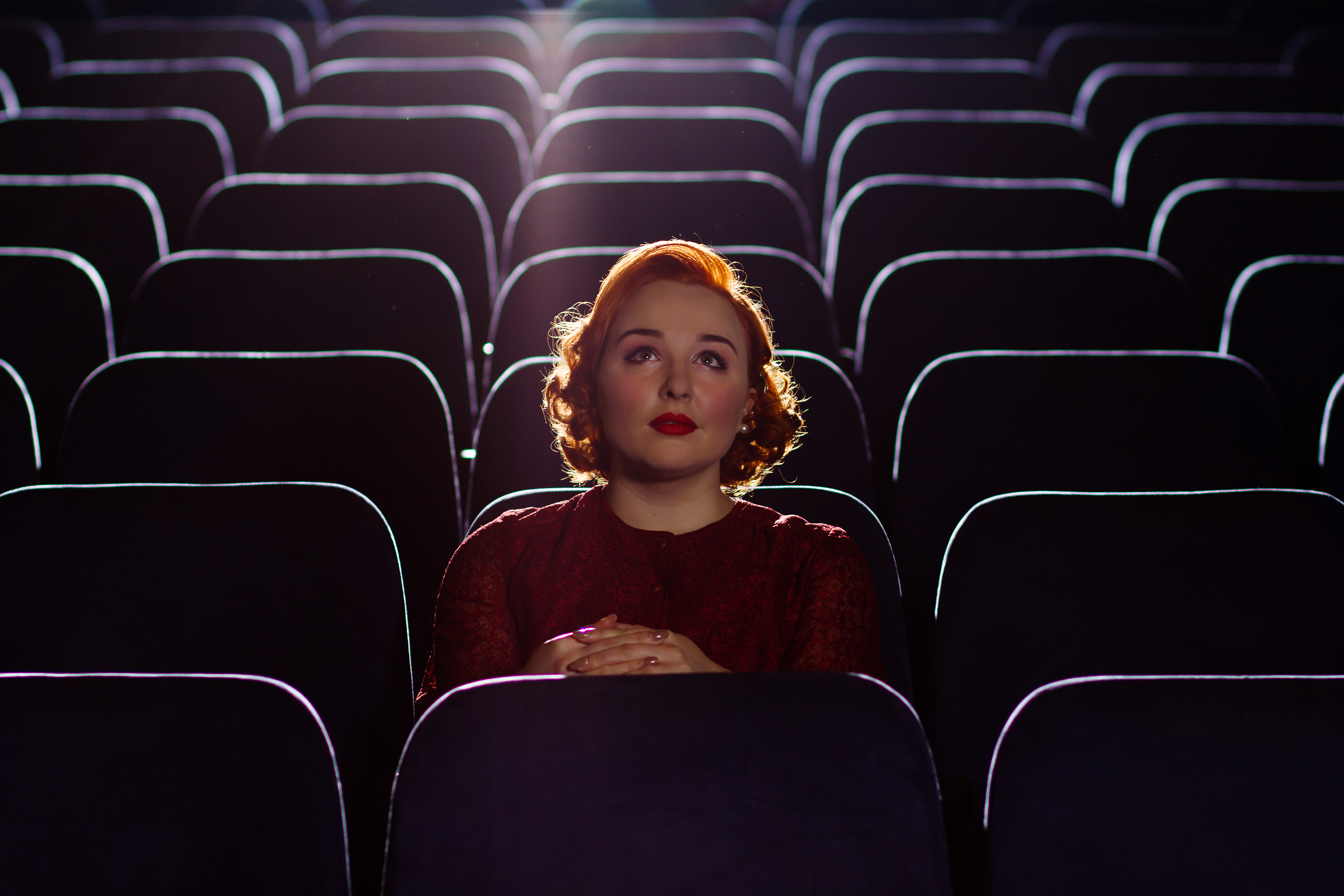 A woman sitting in a movie theater