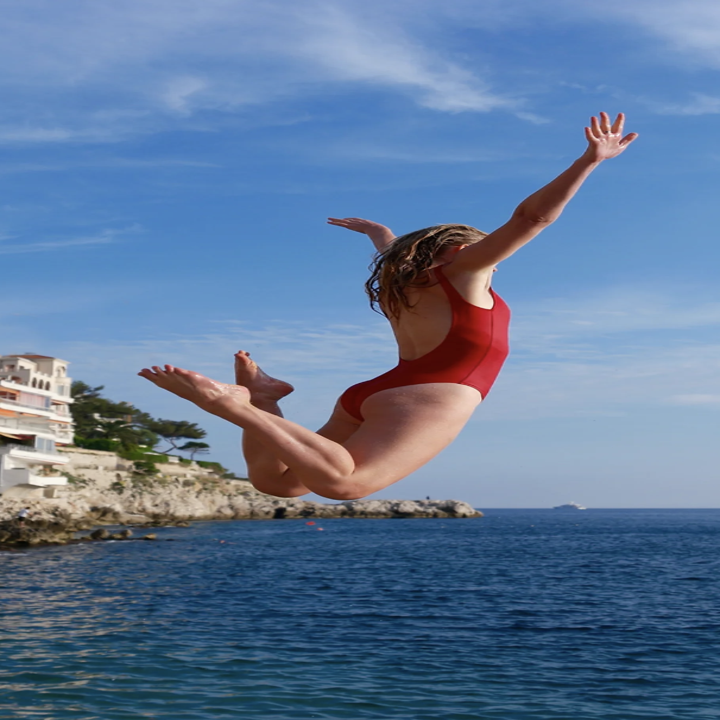 traveler jumping into water