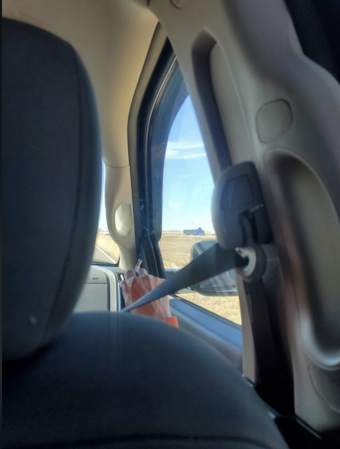 A passenger smoking in the car