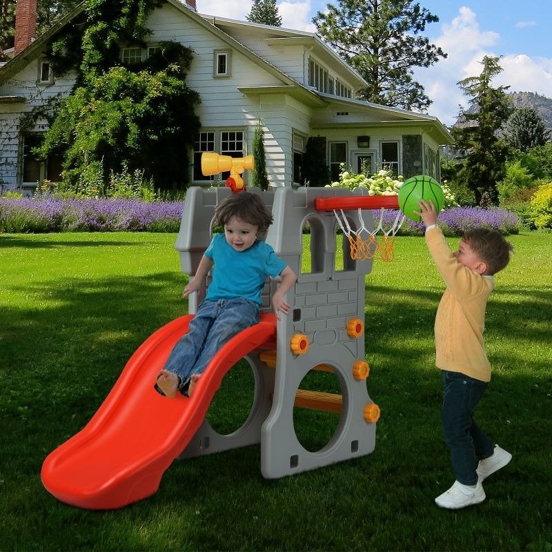 Kids play on a climber and slide