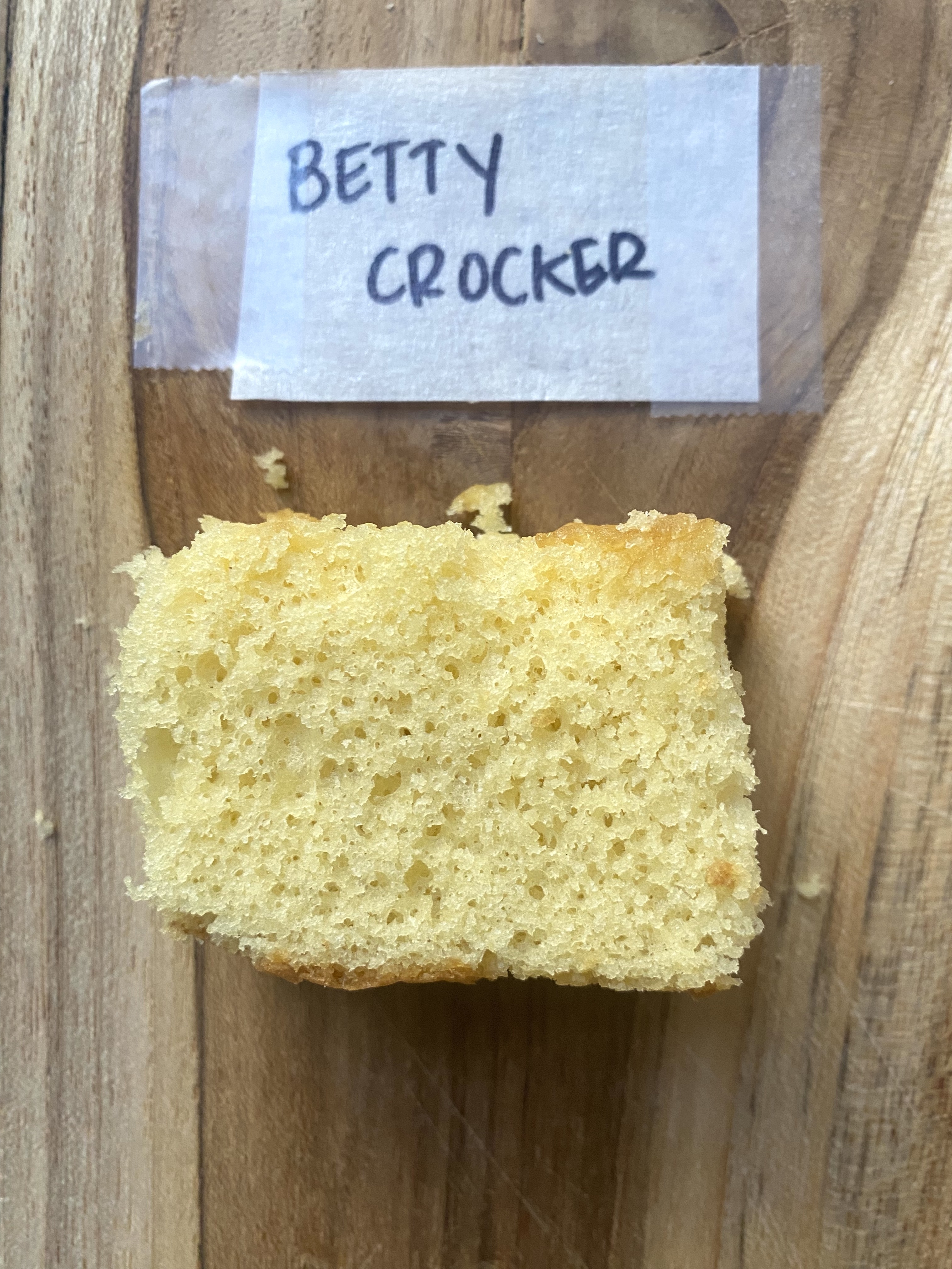 a slice of betty crocker cake on a wooden cutting board