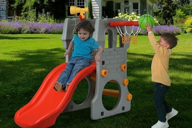Kids play on a climber and slide
