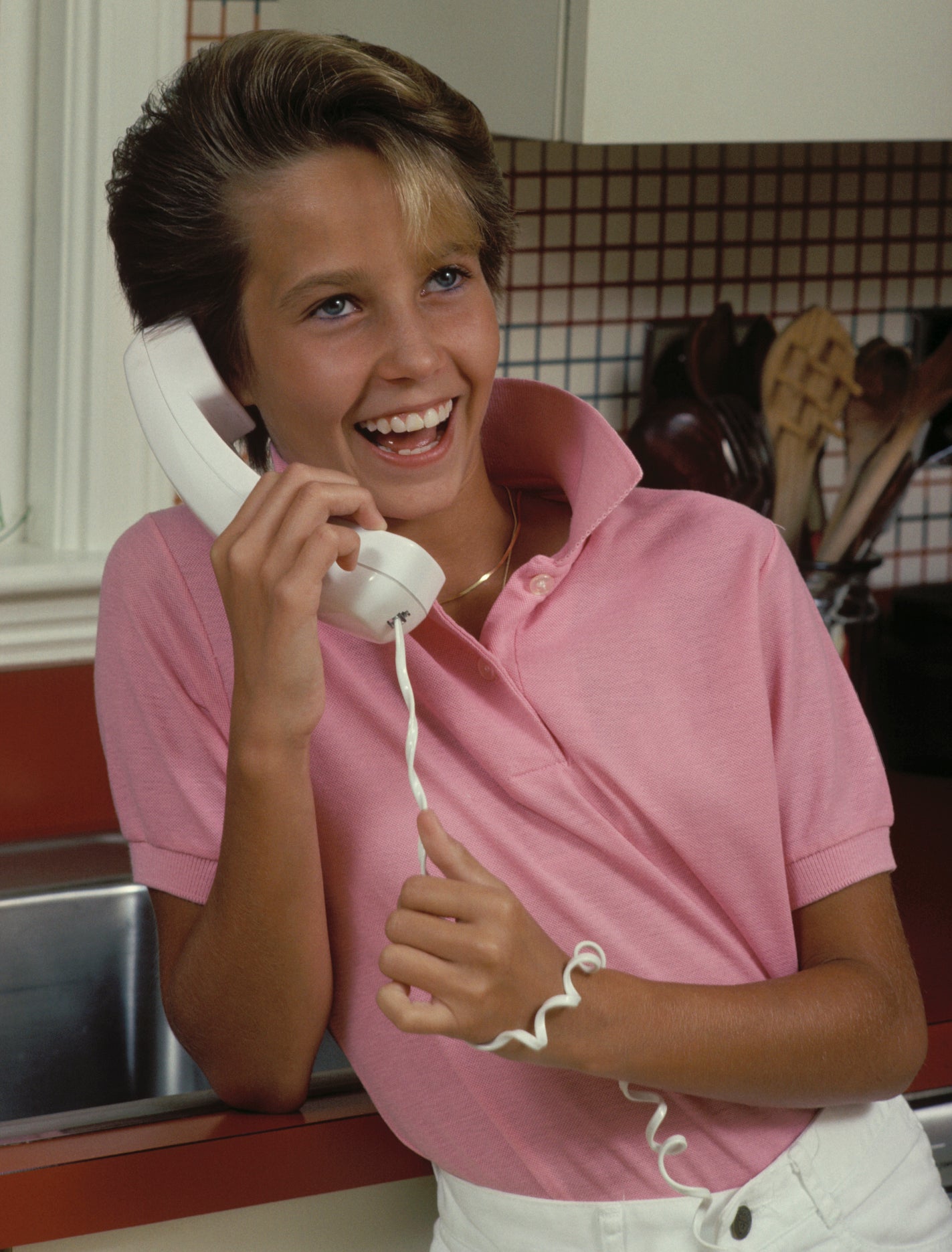 A young boy talking on the phone