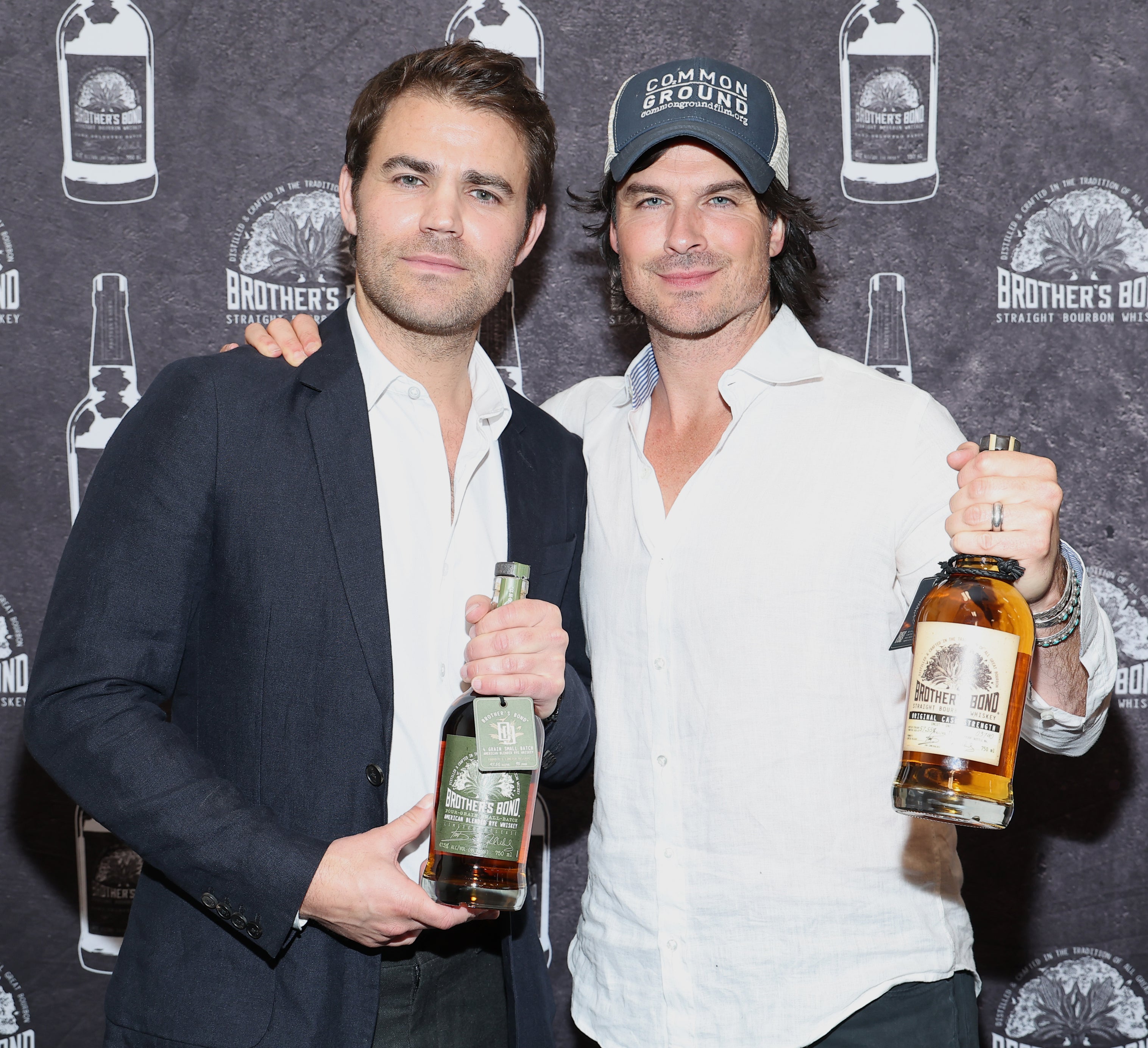 the two holding a bottle of their bourbon