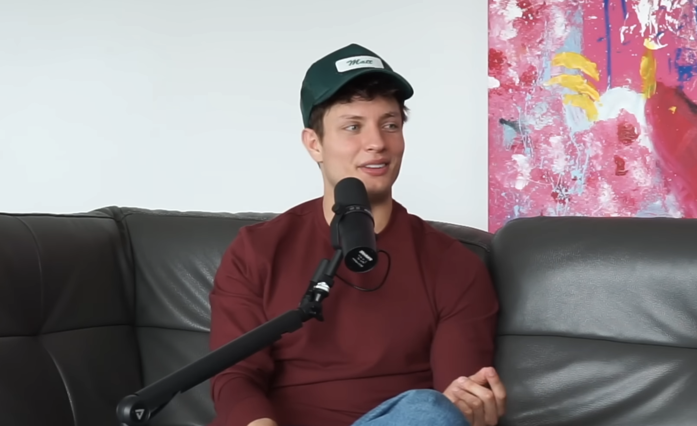 Closeup of Matt Rife sitting on a couch during the podcast interview