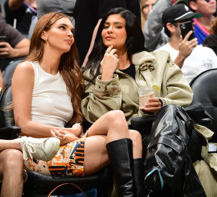 kendall and kylie sitting at a sports game