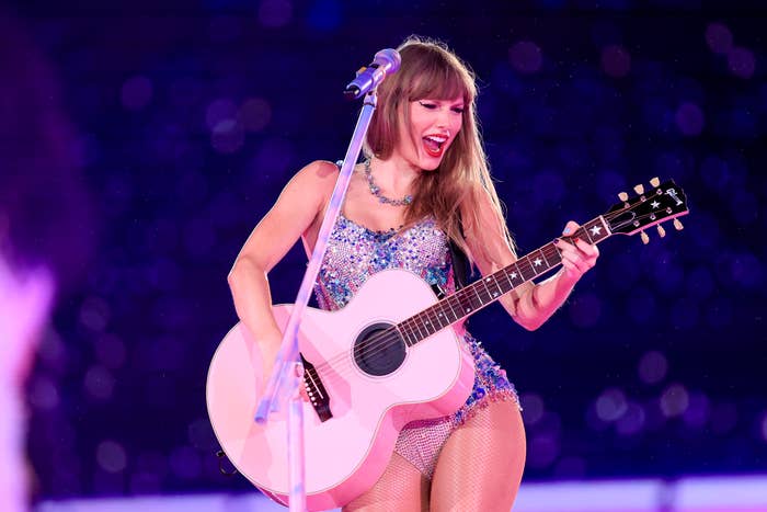 Taylor playing the guitar on stage