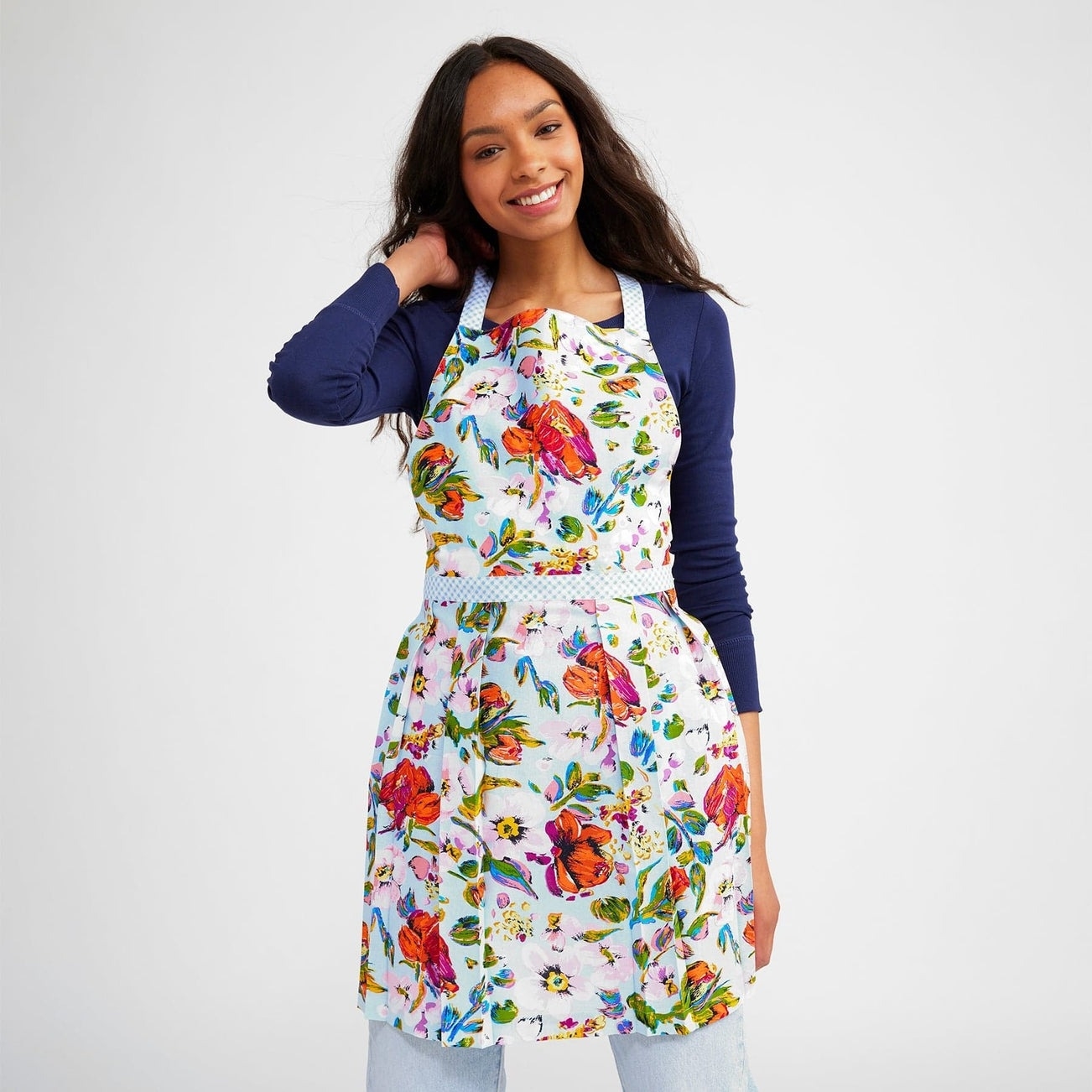 model wearing colorful floral-print apron