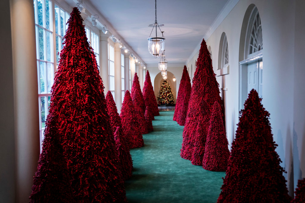 red trees lining a White House hallway