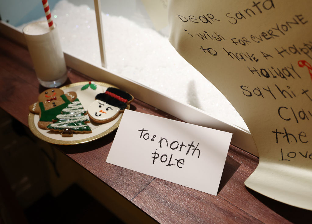 A note sitting next to a plate of cookies says &quot;To: North Pole&quot;