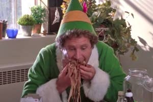 Buddy the Elf shoving breakfast spaghetti into his mouth
