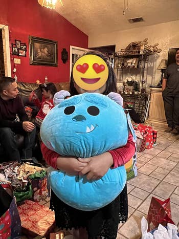 reviewer hugging the sully squishmallow
