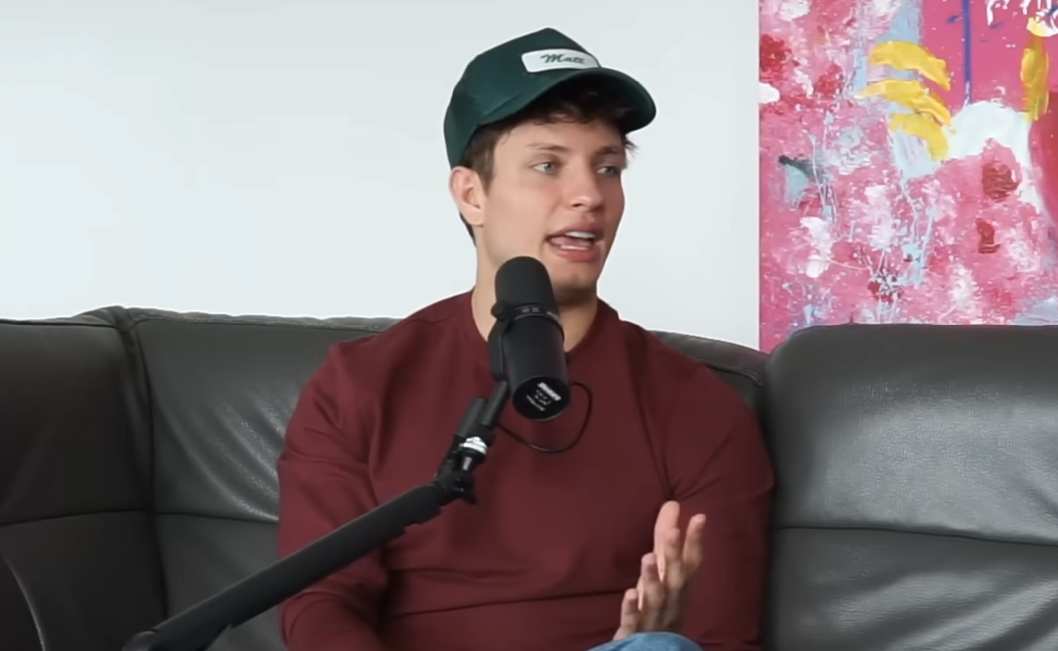 Closeup of Matt Rife sitting on a couch for the podcast interview