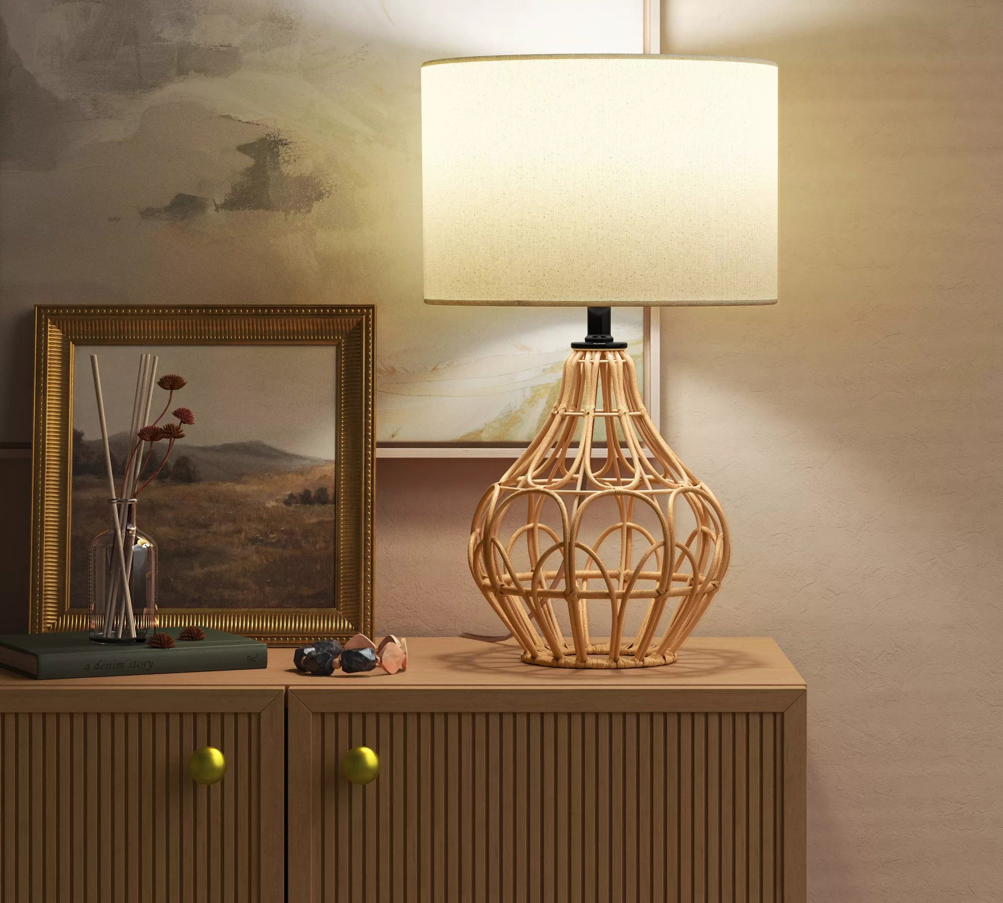 The lamp featuring a tan rattan base and a cream fabric shade