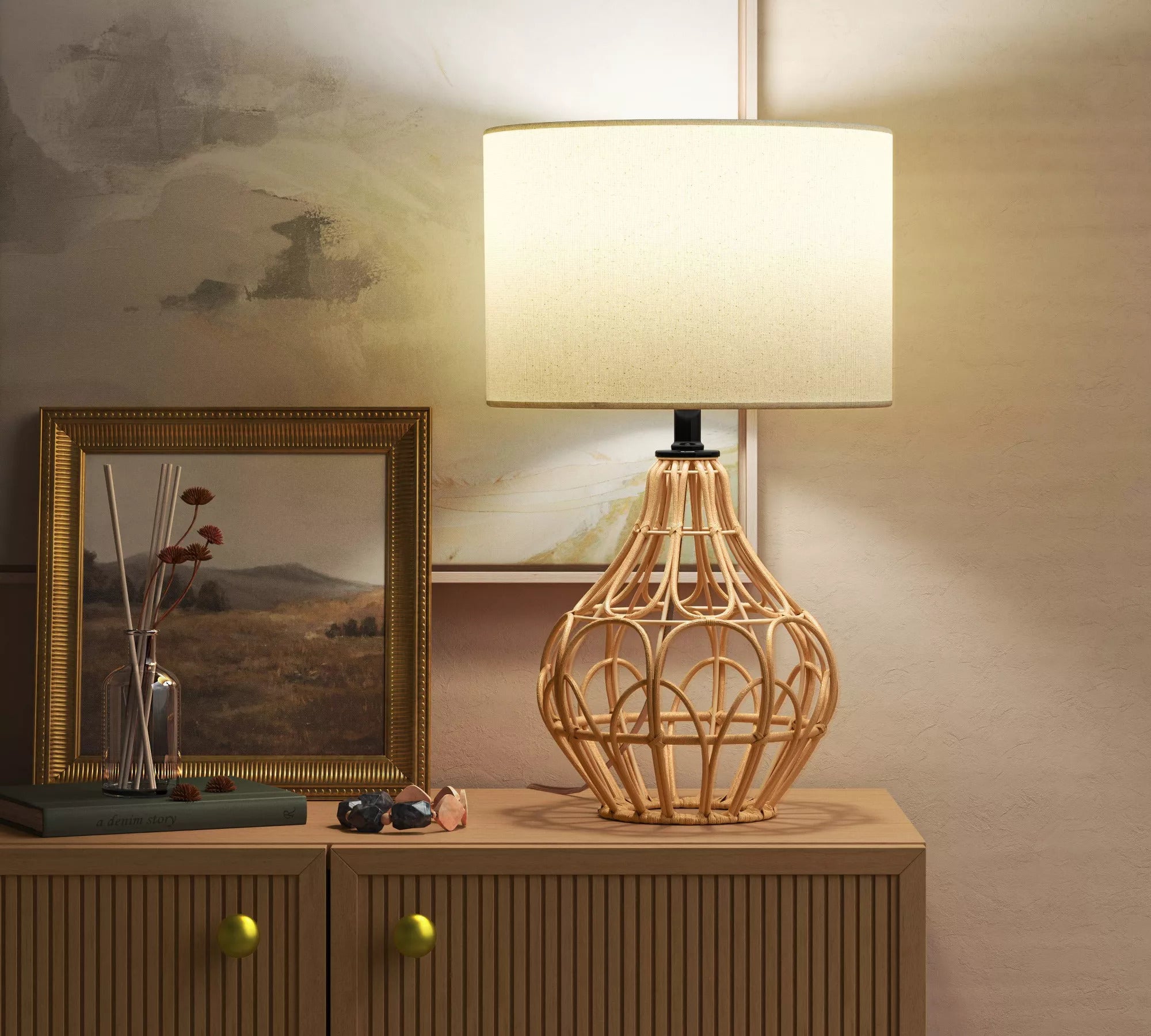 The lamp featuring a tan rattan base and a cream fabric shade