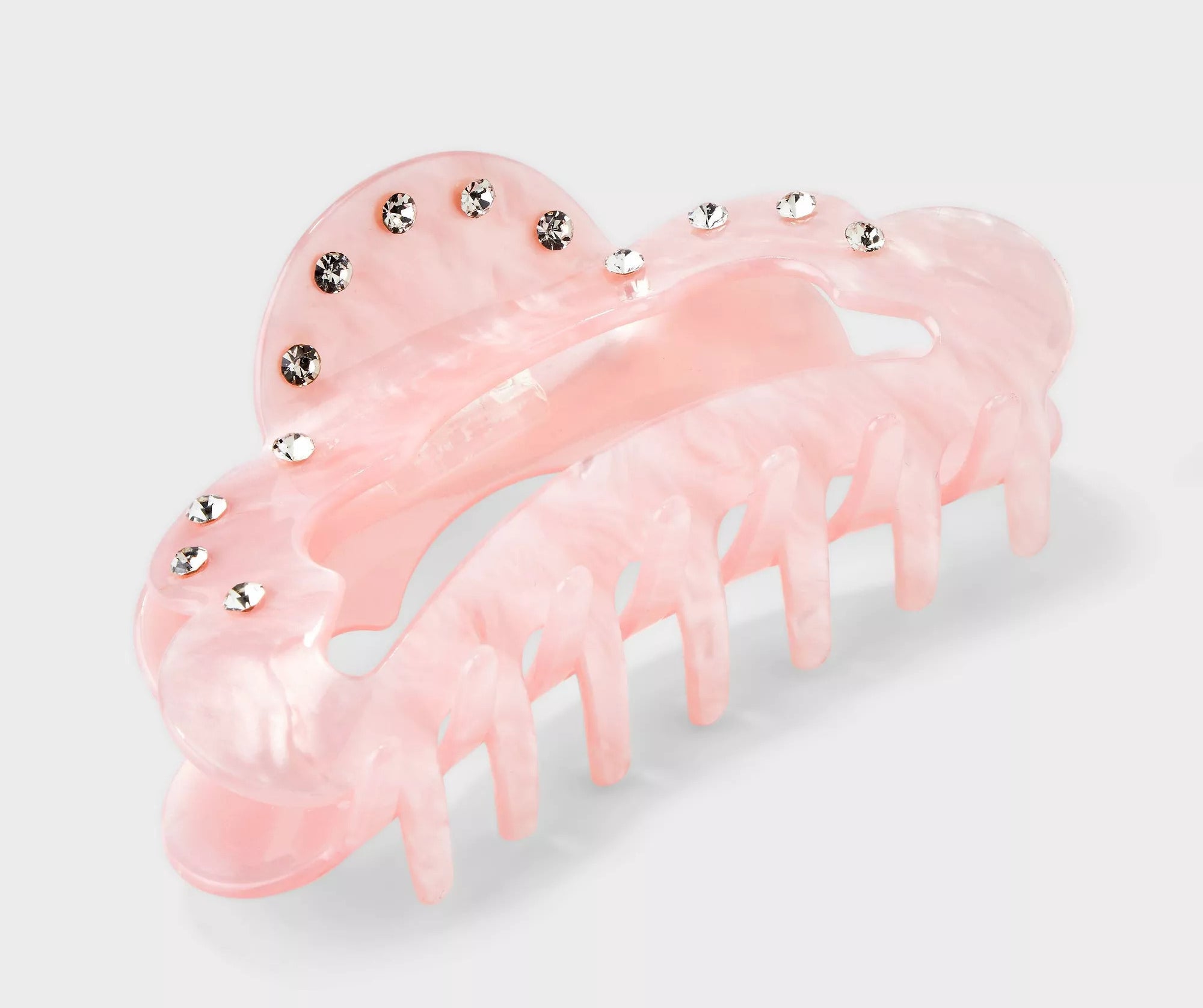 The pink claw in a cloud shape decorated with rhinestone accents