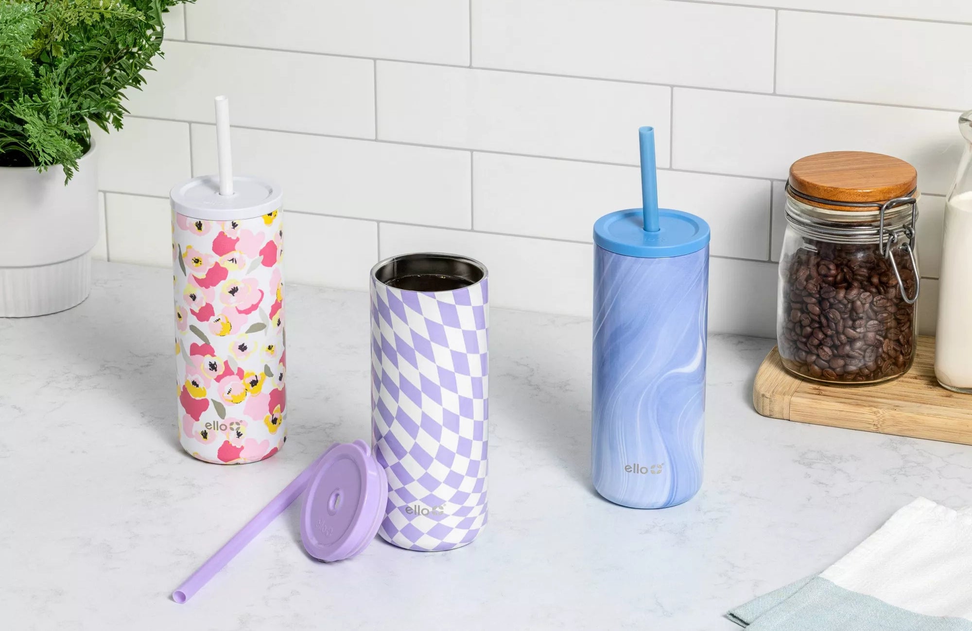 The tumbler with lid and straw in floral, check, and marble designs