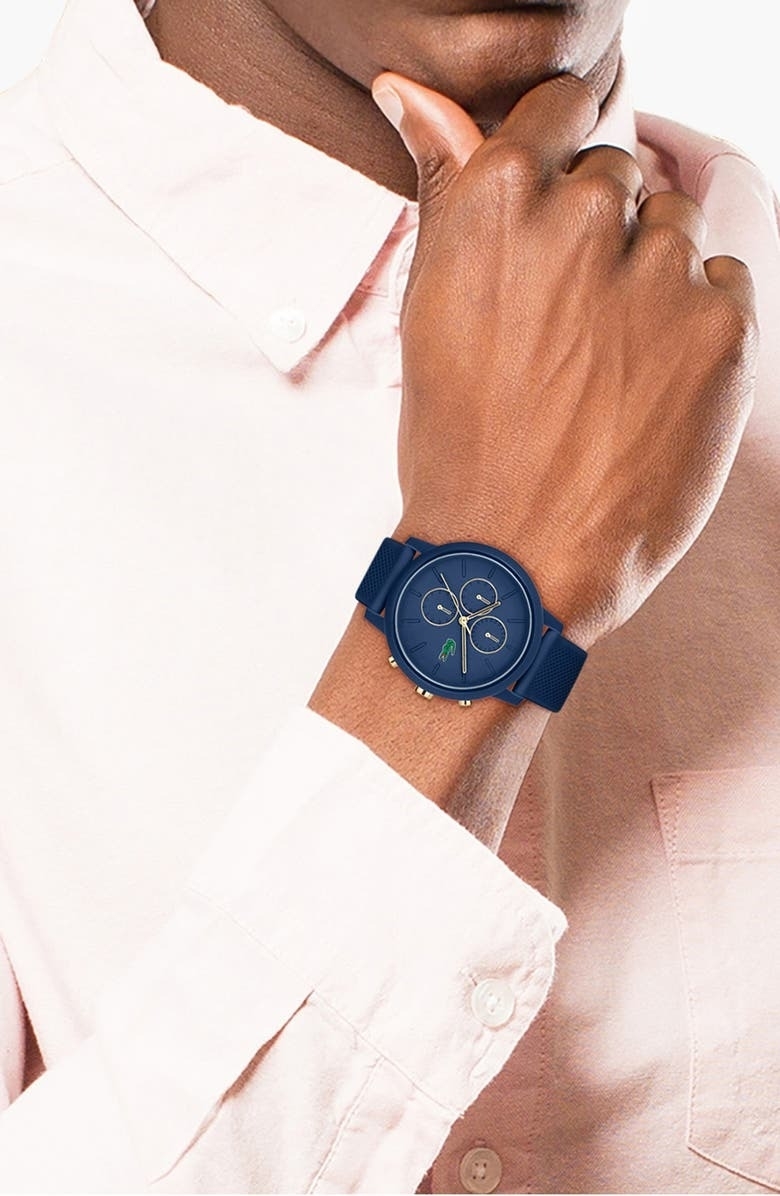 model wearing navy blue Lacoste watch