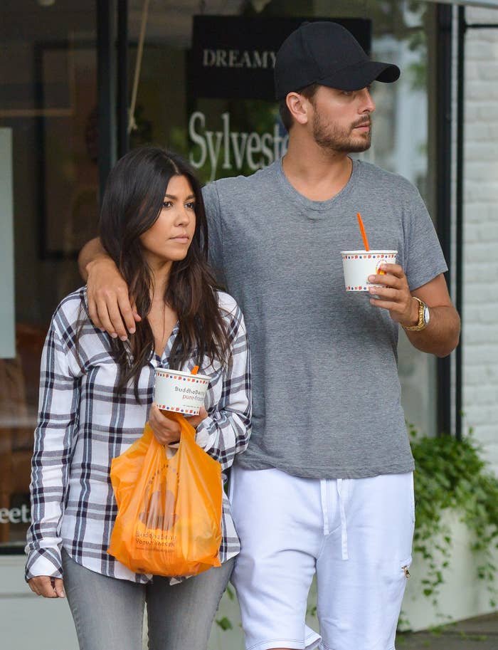Close-up of Scott with his arm around Kourtney&#x27;s shoulder as they walk out of a fro yo shop