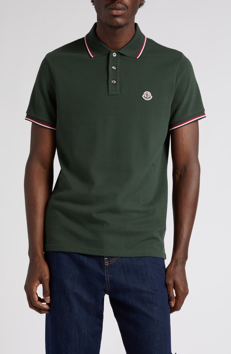model wearing green short sleeve Moncler polo shirt