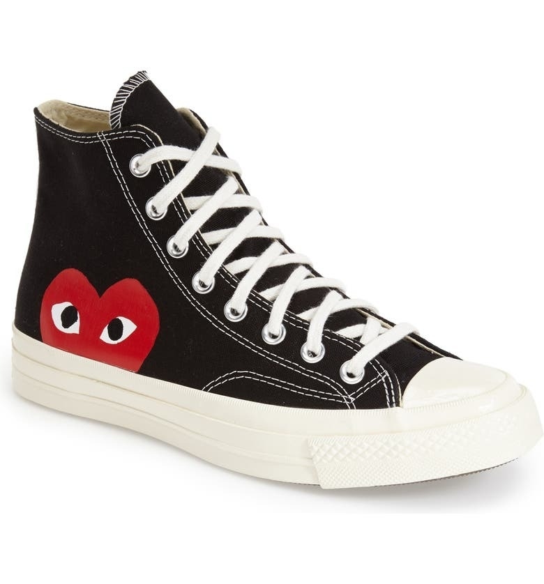 the black and white high tops with a half heart and eyes icon on the bottom