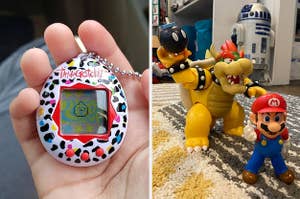 reviewer holding colorful Tamagotchi toy with virtual pet on the screen and Bowser, Bob-omb, and Mario action figures