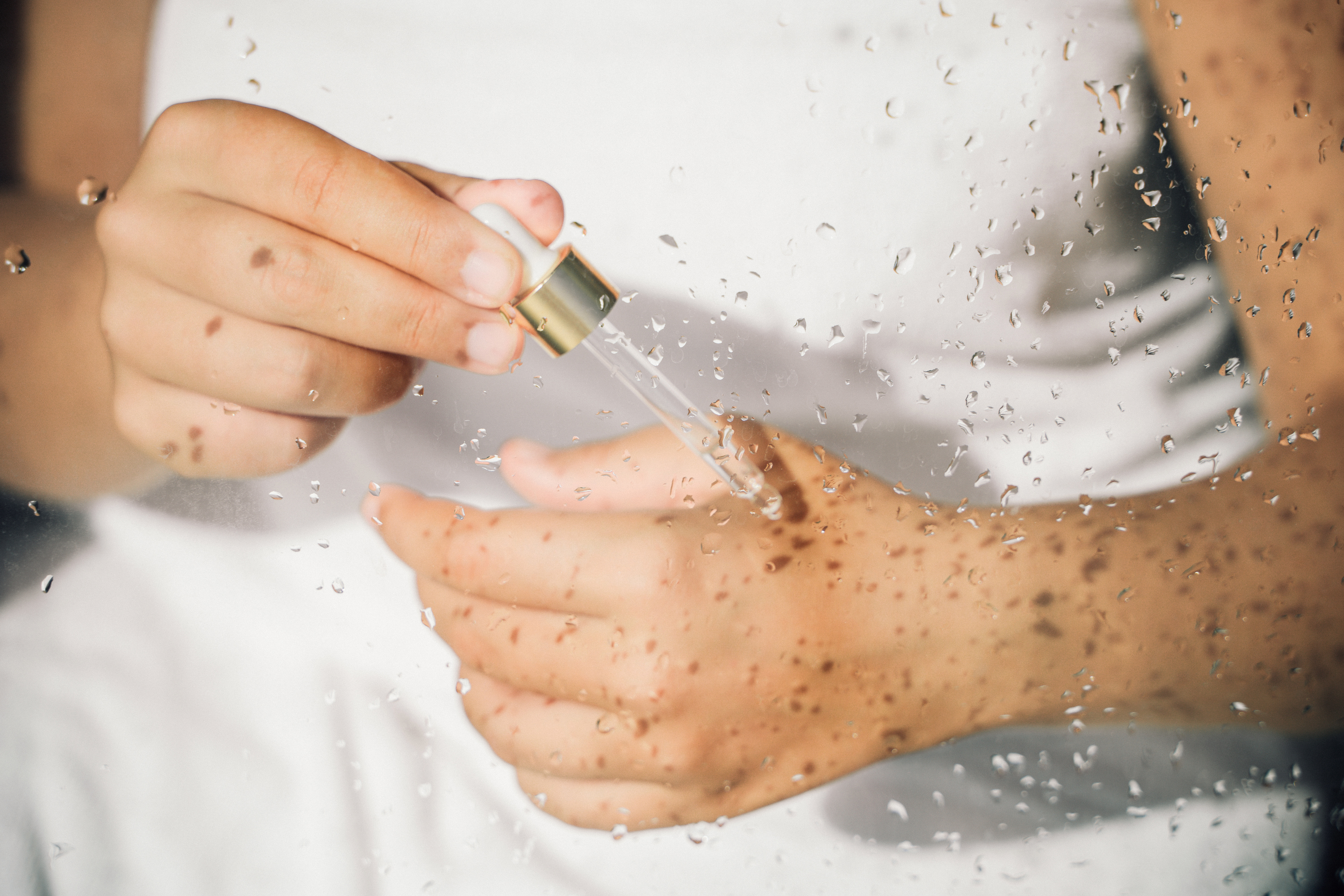 person applying oil to their skin