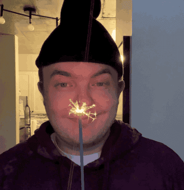 author gif holding a sparkler