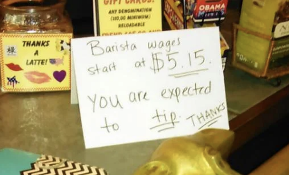 sign at the counter reads, barista wages start at $5.15 you are expected to tip thanks