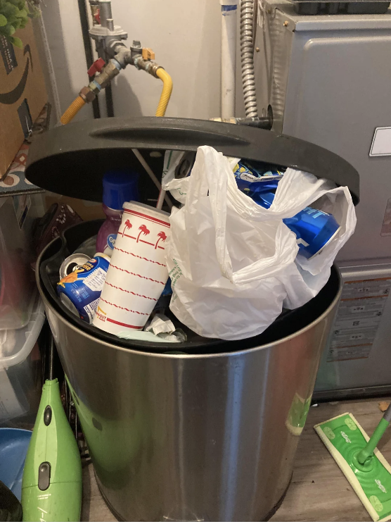 messy overflowing trash can with in&#x27;n&#x27;out, mac n&#x27; cheese, and soda cans