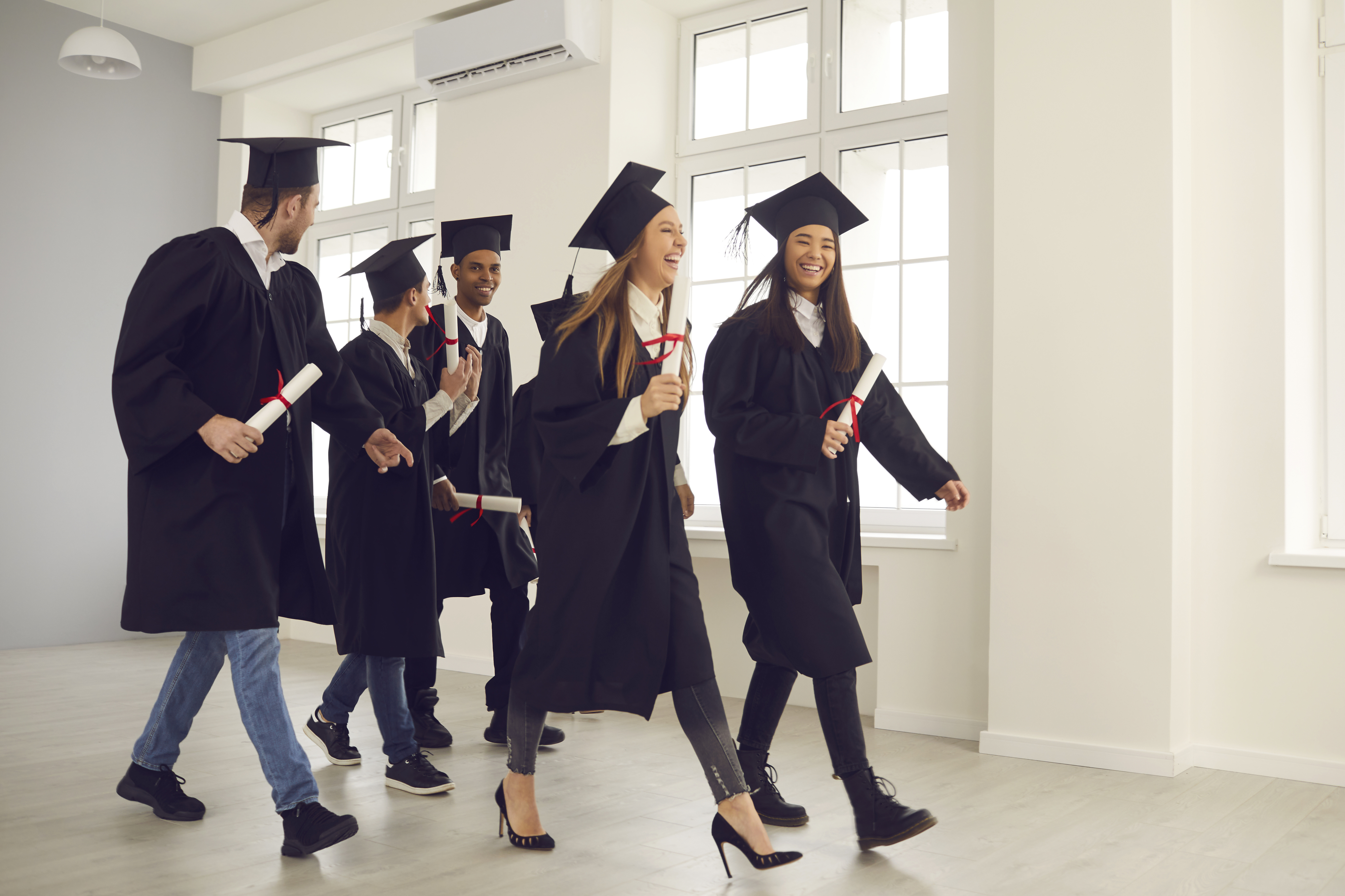 Graduates walking with their diplomas