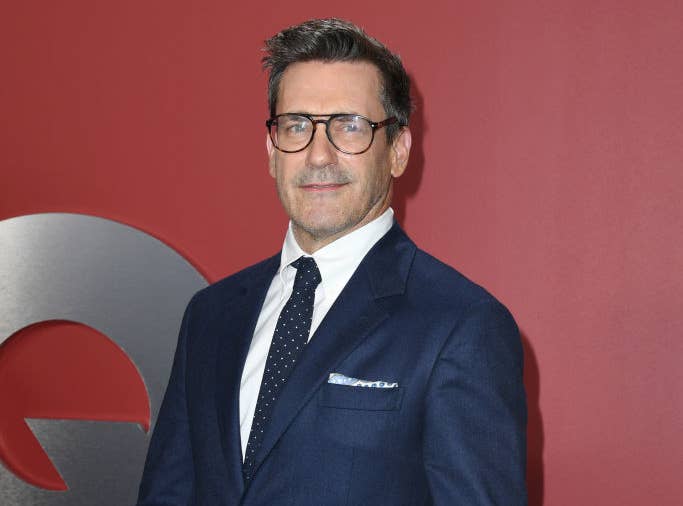 Closeup of Jon Hamm on the red carpet in a suit and eyeglasses