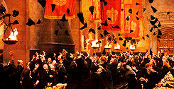 Young wizards throwing their hats in the air in Hogwarts&#x27; Great Hall.
