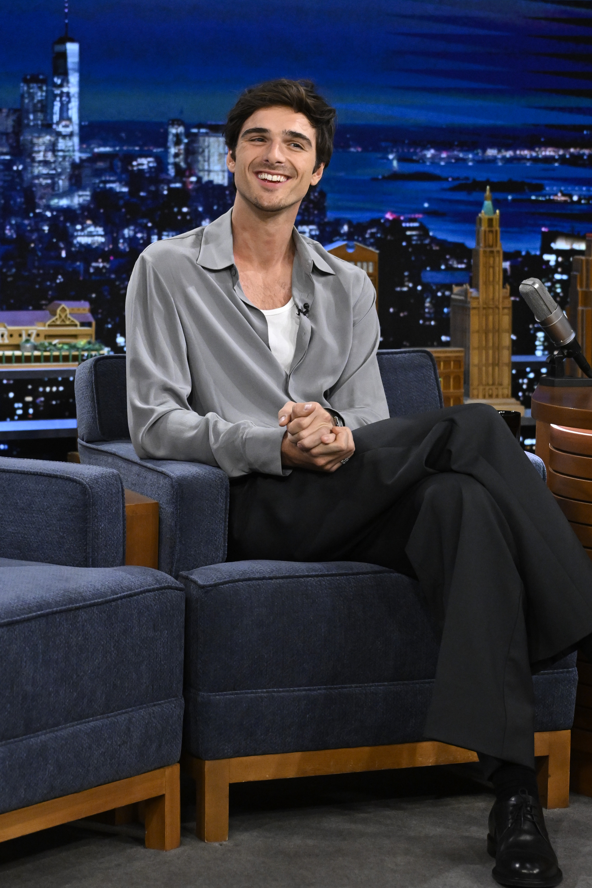 Close-up of Jacob seated and smiling on the talk show